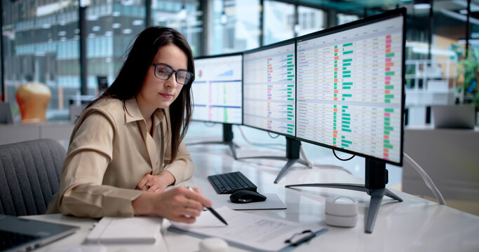 Woman Analyzing Medical Billing Spreadsheet Data On Computer