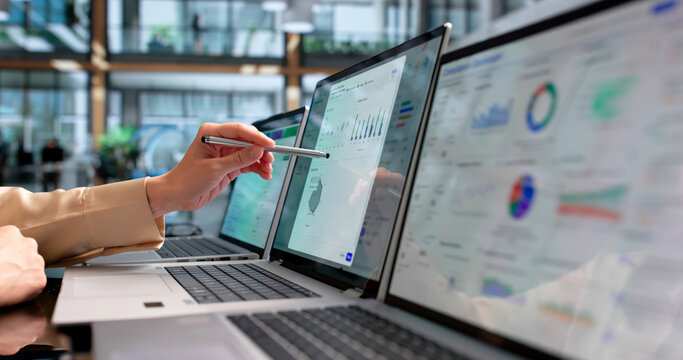 Young Female Compliance Officer Analyzes Financial Data Dashboard