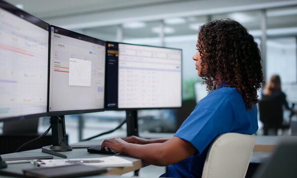Young African Female Healthcare Worker Updates Patient&rsquo;s Electronic Medical