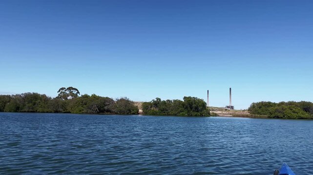Daytime view of Adelaide Dolphin Sanctuary with Torrens Island Power Station in the distance