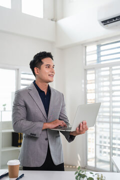 Smiling confident business man leader looking aside standing in office. Professional businessman manager executive or male worker, entrepreneur  thinking of career goals.