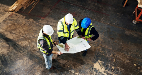 Naklejka premium Top view, engineer and planning with blueprint at construction site, building development or layout. Architect team, people and discussion with document for infrastructure design, review and above