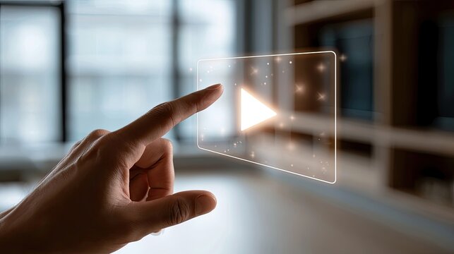 Hand presses illuminated play button on transparent digital interface