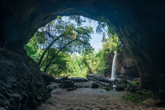 Majestic Waterfall View from Cave Opening in Lush Tropical Landscape