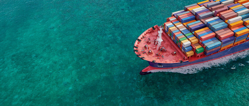 Container Ship Sailing Across Turquoise Ocean
