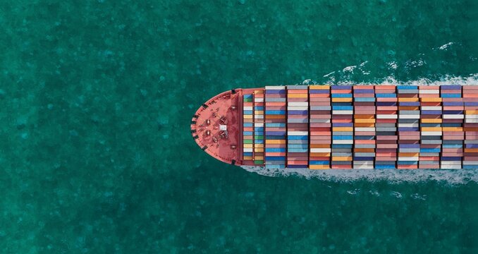 Aerial Container Ship Sailing Across Turquoise Ocean