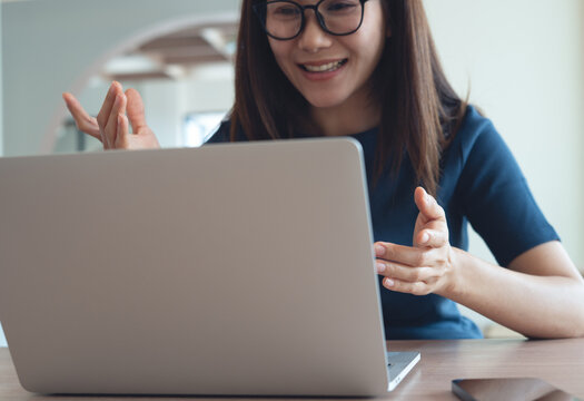 Online conference and business meeting, working from home. Woman in casual clothes talking on a video call via laptop, online meeting, remote work