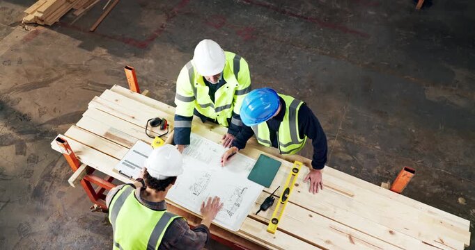 Above, carpentry and blueprint with men in warehouse together for discussion or meeting. Planning, document and teamwork with people in woodworking workshop for manufacturing partnership or contract