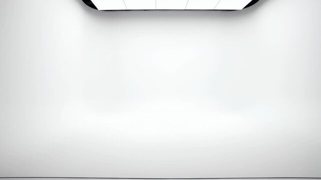 Minimalist white wall with overhead lighting, creating a clean and empty backdrop for creative display or presentation