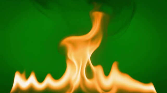 Mesmerizing Dance of Bright Orange Flames and Smoke Flickering Gracefully Against Vibrant Green Abstract Background