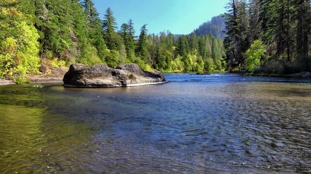 Calm turquoise canyon river flanked by tall dry rock walls