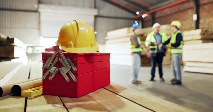 Carpentry, helmet and toolbox in warehouse with people talking for manufacturing or production. Collaboration, engineering and hardhat with designer team in woodworking factory for discussion