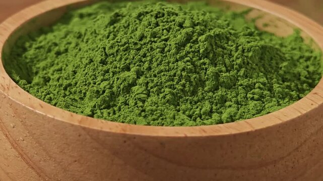 Matcha powder in wooden bowl.