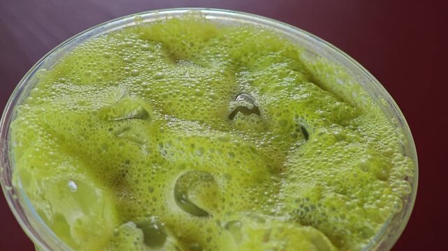 Iced matcha latte in cafe.