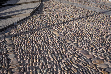 Texture of traditional cobblestones made of river rocks arranged in a curve in a historic Cusco plaza © WILL PHOTOGRAPHY