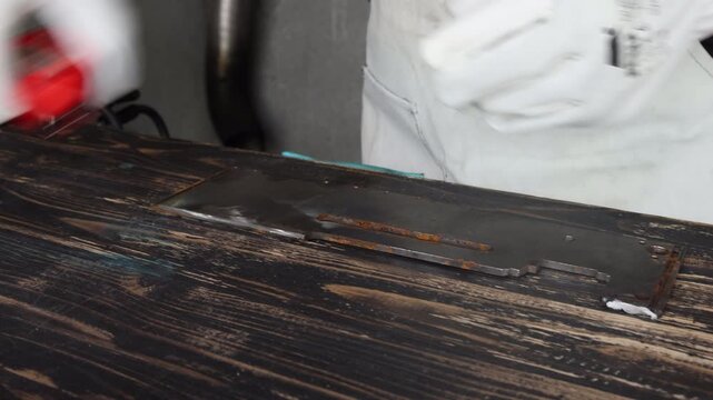 Selective focus on craftsman hands taking measurements on wooden workbench before cutting