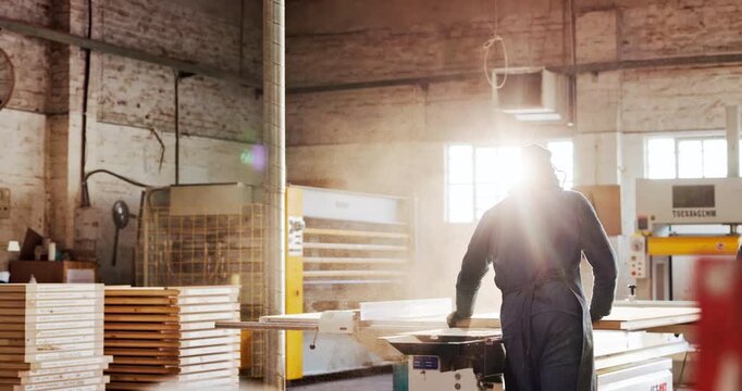 Carpentry, machinery and process with man in workshop for production or manufacturing career. Creative, design and professional with back of person in woodworking factory for furniture industry