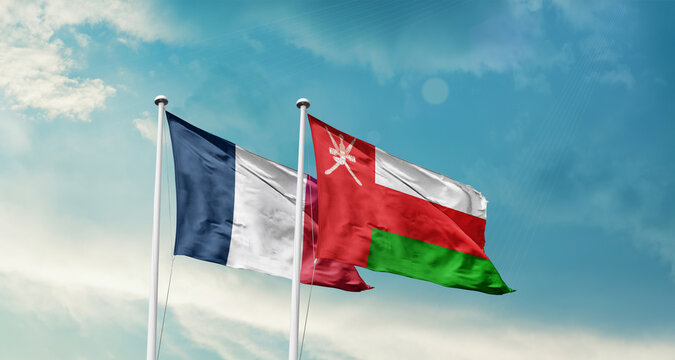France Oman friendship flags are waving in the sky. Two country flag for agreement or deal. France Oman national flag for commitment.