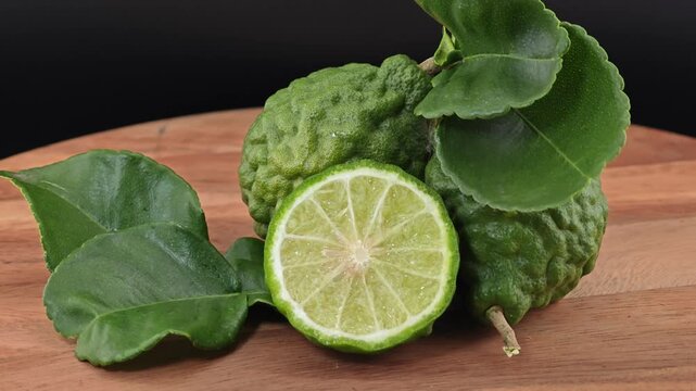 Sliced kaffir lime on wooden board.