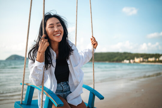 Mindful woman connecting with nature and feeling the breeze during a peaceful morning on the beach