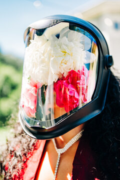 Woman wears a face shield filled with fresh peonies