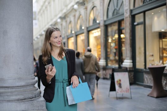 Happy woman shopping in a beautiful arcade