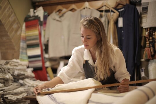 Artisan woman measuring fabric in a textile studio