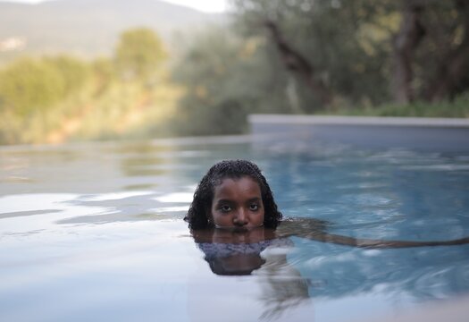 Young woman looking intensely from pool water