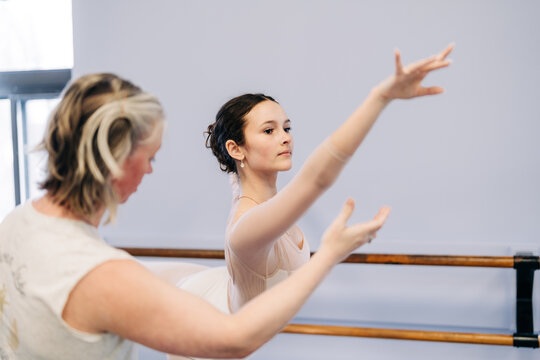 Ballet instructor teaching student elegant dance movements