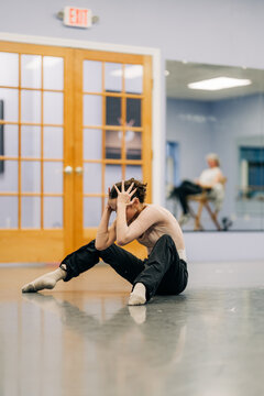 Dancer experiencing frustration and mental block during rehearsal