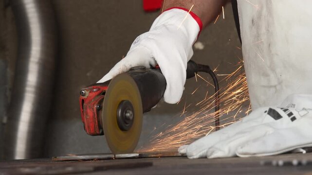 Dynamic golden sparks flying against dark background in industrial metalworking