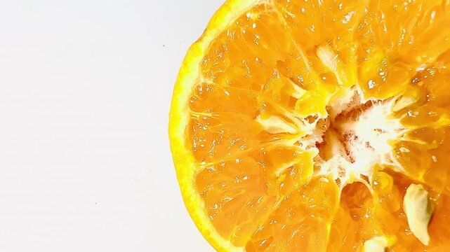 A close-up of a fresh half cut orange showing juicy pulp on a pure white background. Vibrant citrus fruit slice rich in vitamin C, ideal for healthy lifestyle content.