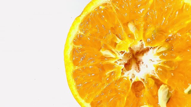 A close-up of a fresh half cut orange showing juicy pulp on a pure white background. Vibrant citrus fruit slice rich in vitamin C, ideal for healthy lifestyle content.