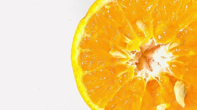 A close-up of a fresh half cut orange showing juicy pulp on a pure white background. Vibrant citrus fruit slice rich in vitamin C, ideal for healthy lifestyle content.