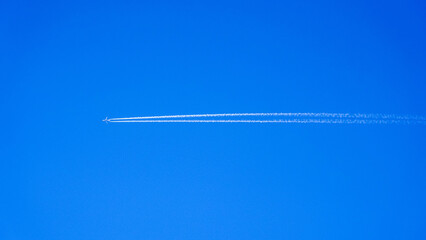 Aircraft Contrails In Clear Blue Sky © ANDREW NORRIS