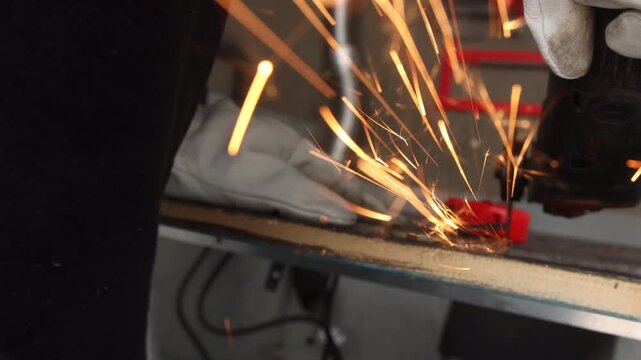 Dynamic golden sparks flying against dark background in industrial metalworking