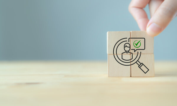 Target Customer and recruitment concept. Wooden blocks showing a magnifying glass, customer icon, and approval check. Target audience identification, recruitment, customer selection and qualification.