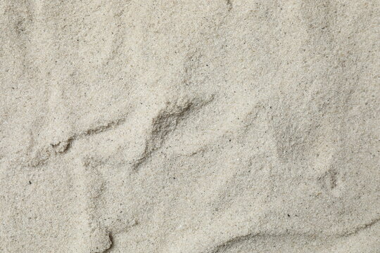 Natural sand texture background, beige sand surface