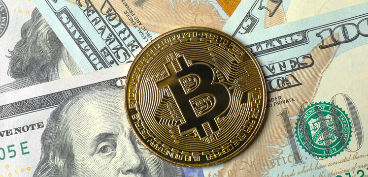 Metal shiny bitcoin crypto currency coins on US dollar bills. Electronic decentralized money concept. Banner template 