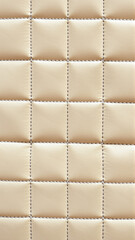 Obraz premium beige leather upholstery with quilted pattern in elegant indoor furniture setting top-down perspective clean and neutral background copy space for editorial and educational use.