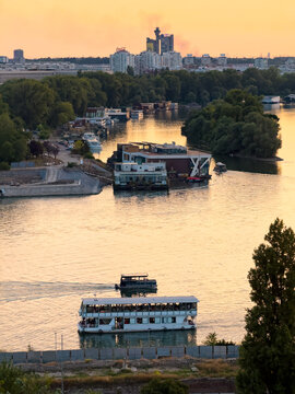 Passenger boats cruising on Sava River during Belgrade sunset