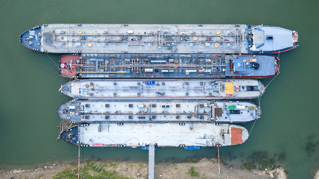 Overhead View of Commercial Barges Parked Parallel on Water