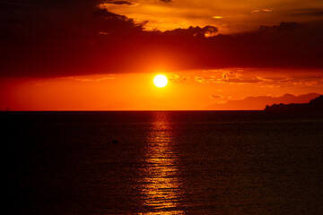 Fototapeta premium Dramatic Sunset Over Calm Water With Colorful Evening Sky