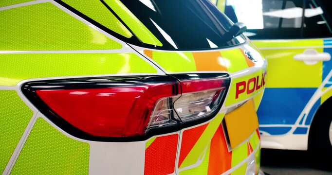 Police car - scene of emergency services' police force vehicle in action featuring a UK cop car on patrol with lights and siren on, in response to an arrest or incident.