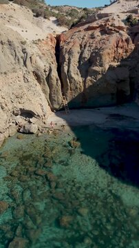 Discover the breathtaking beauty of Tsigrado Beach Milos as vibrant blue waters meet rugged cliffs. Experience the serene landscape, ideal for relaxation and exploration in the Cyclades