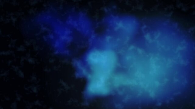 Abstract deep sapphire blue ink swirls and expands creating an ethereal liquid motion background texture
