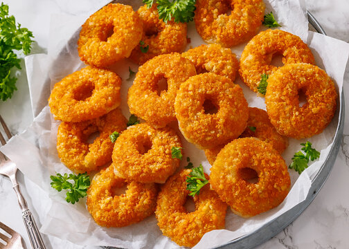 Golden Breaded Cheese Wheels On Paper on a tray