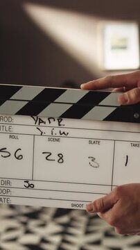 Producer, hands and action with clapperboard for movie scene, take or roll in filmmaking industry. Closeup, people or director with slate for acting, visual cue or shoot in recording studio or set
