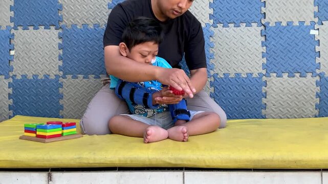Occupational therapy session for child with special needs using sensory toy
