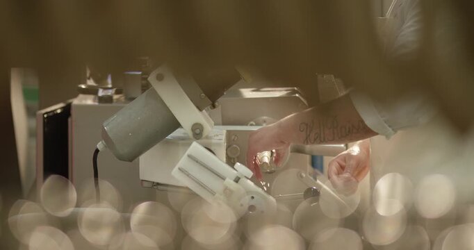 Hand operates a food processing machine in factory